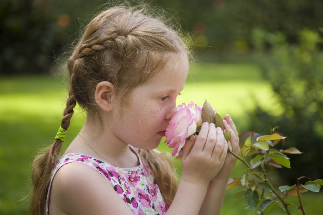 Girl smelling rose